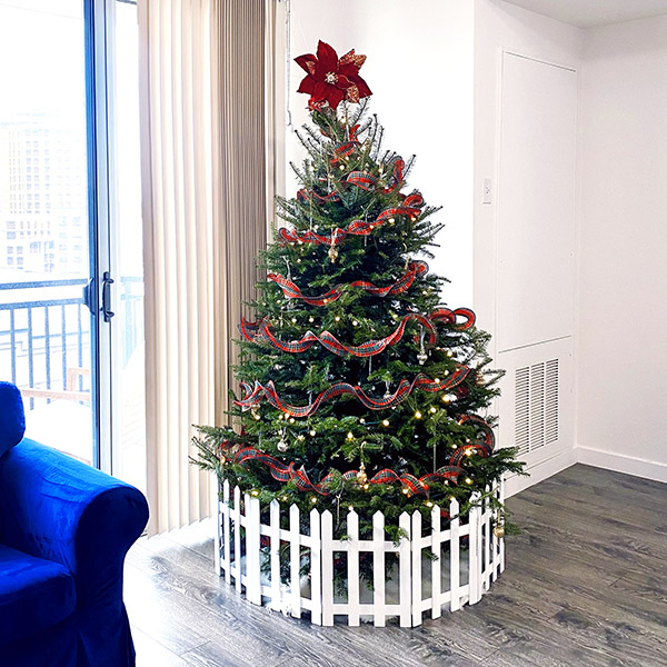 Christmas tree with puppy fence | Apricot's Home 7-foot Christmas tree with white picket puppy fence | Photo by Mir Martz