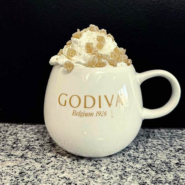 Festive gingerbread latte with whipping cream and candied ginger toppings | Photo by Mir Martz