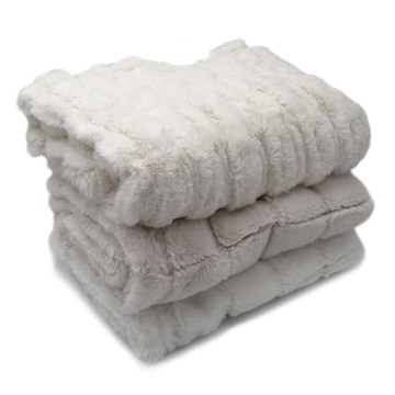 The Heritage Dog Blanket in Gentle Plush folded in a stack | Photo by Mir Martz